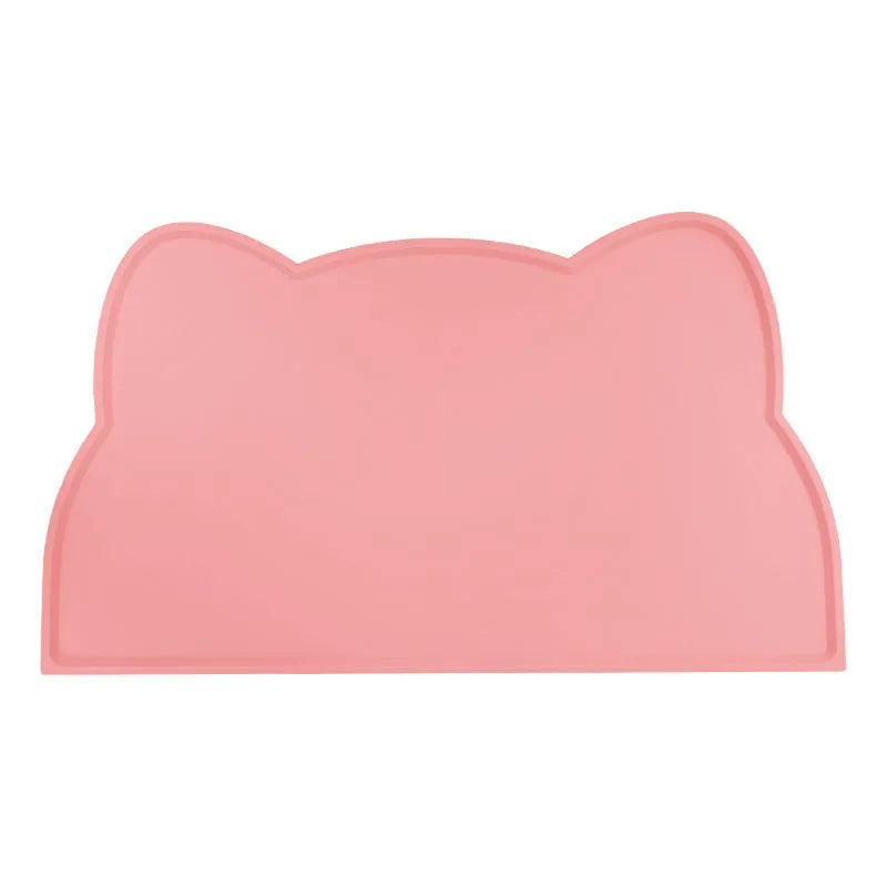 Blue silicone cat head-shaped pet feeding mat on a wooden floor.