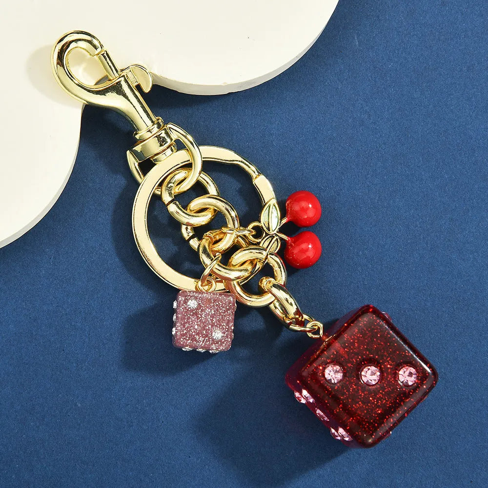 Square metal dice keychain pendant with cherry two-tone electroplated finish on a keyring