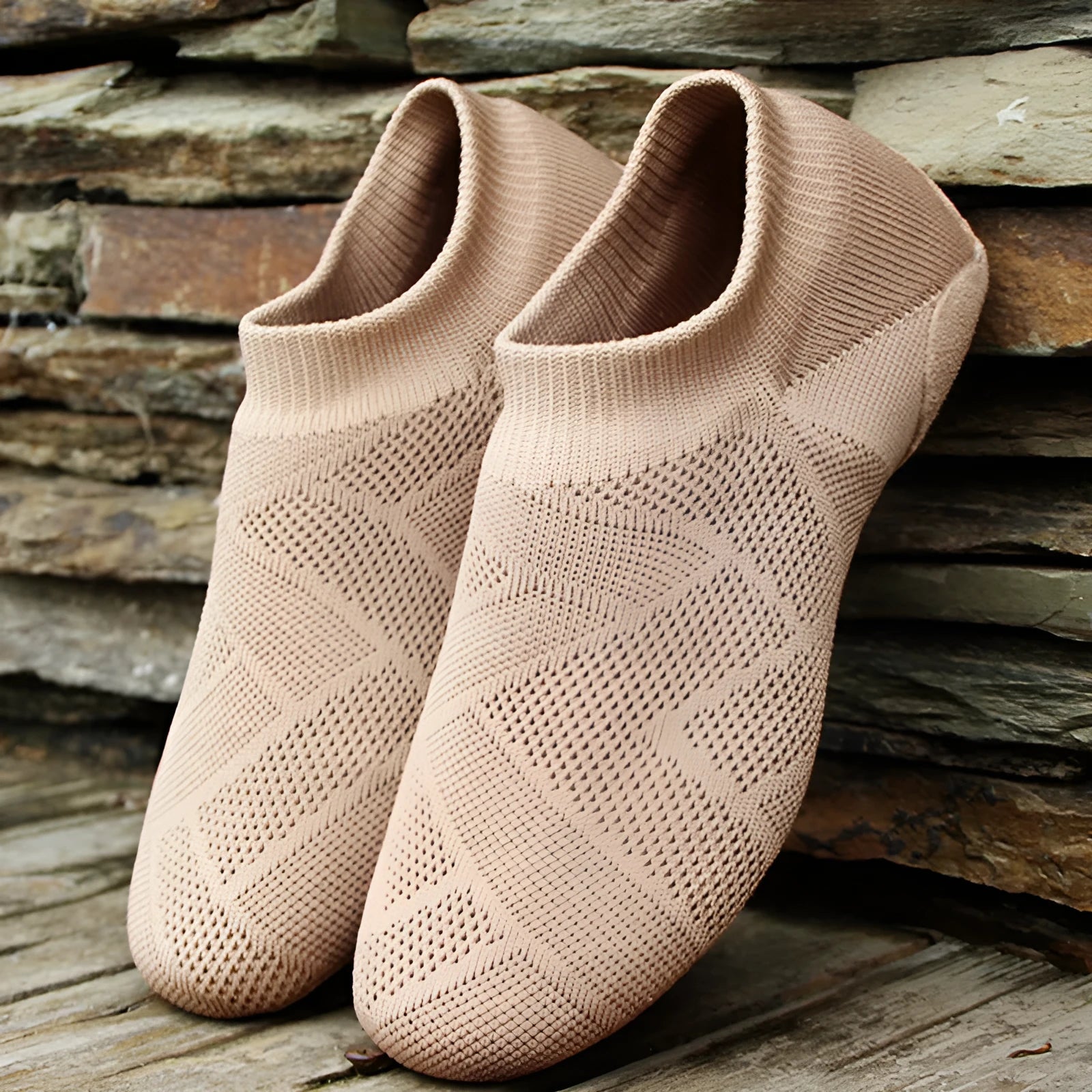Camel coloured Latin dance shoes with cotton mesh upper and leather sole on a plain background.