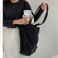 Large corduroy tote bag with soft handle, pleated detailing, and interior zipper pocket. Colour: black.