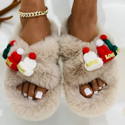 Women's Christmas slippers with a red hat decoration on a faux plush upper, shown in black.