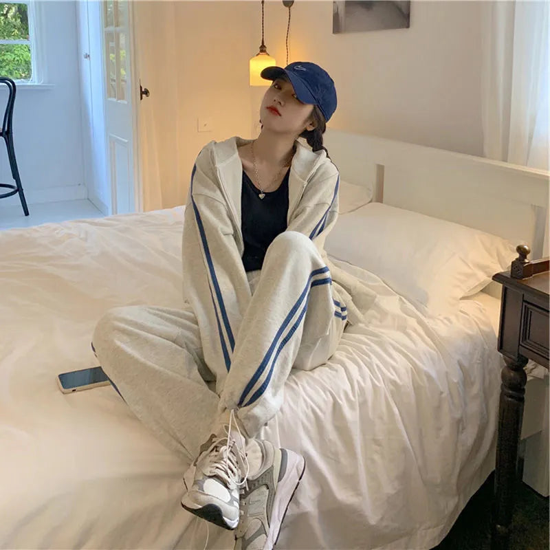 Striped polyester two-piece pants suit set for women in light gray or black with top and trousers coordinated