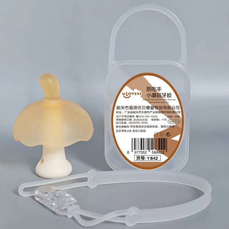 Small mushroom-shaped silicone chewing gum on a chain, in pink or nano colour, inside a transparent box.