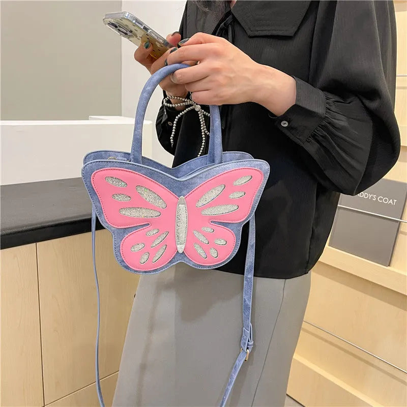 White square women's crossbody bag made of PU leather with contrast colour trim on a table.