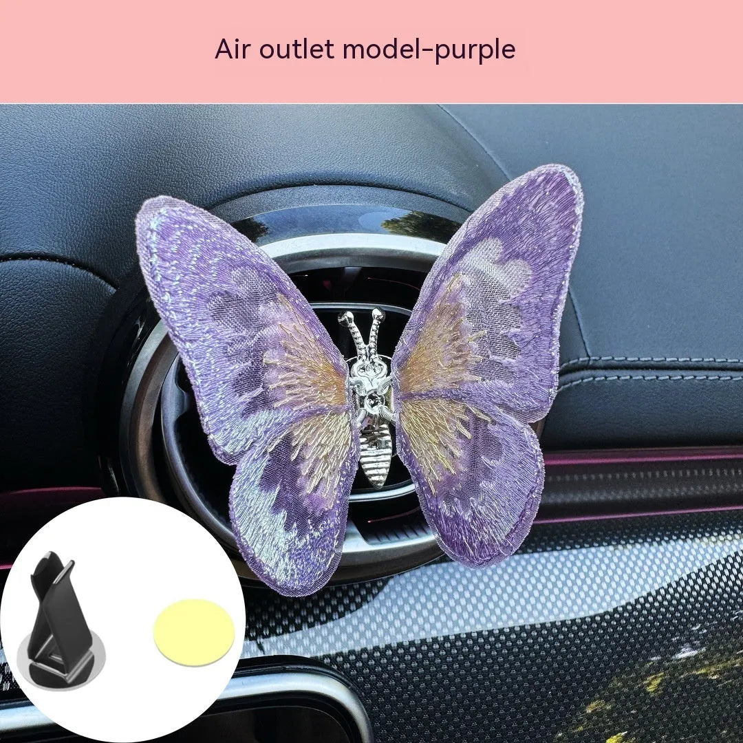 Moving embroidery butterfly decoration on car centre console air vent in pink fabric