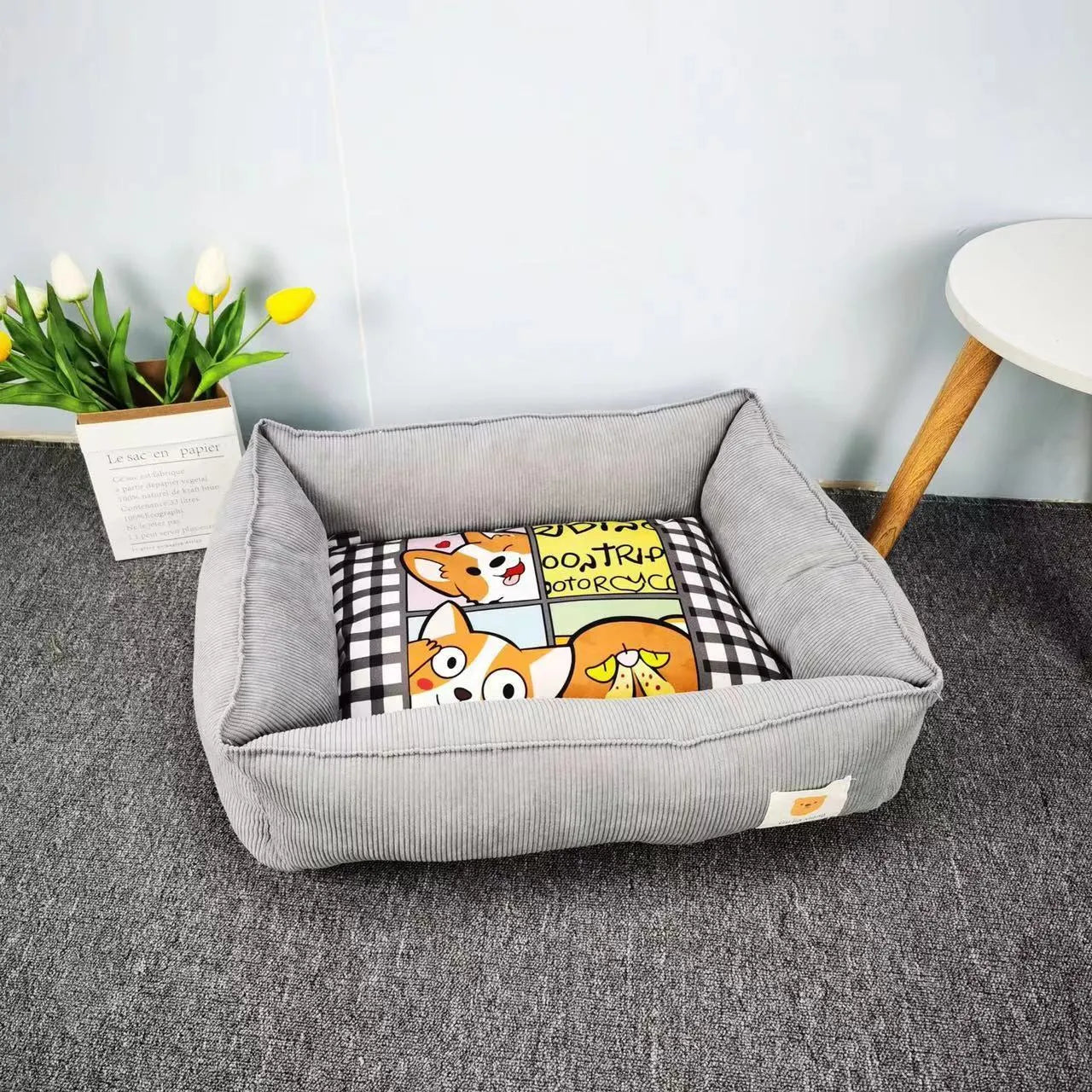 Light blue washable cotton pet winter nest for dogs and cats on a floor.