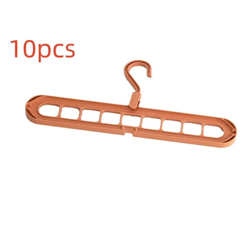 Green plastic nine-hole folding hanger for trousers displayed open and folded flat.