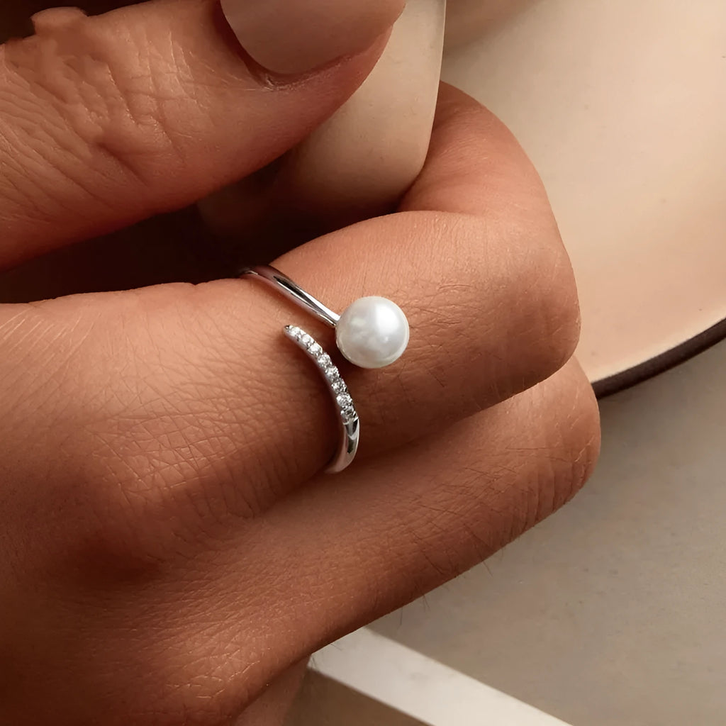Open loop adjustable sterling silver ring with a white shell pearl.