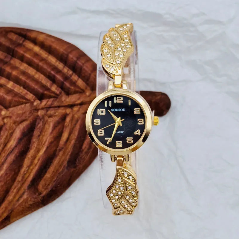 Stainless steel women's watch with round dial on a wrist, showing the Vachette clasp buckle.