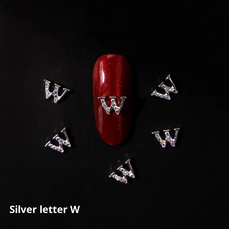 Gold alloy letter A nail ornament charm with crystal detail on a square chain base