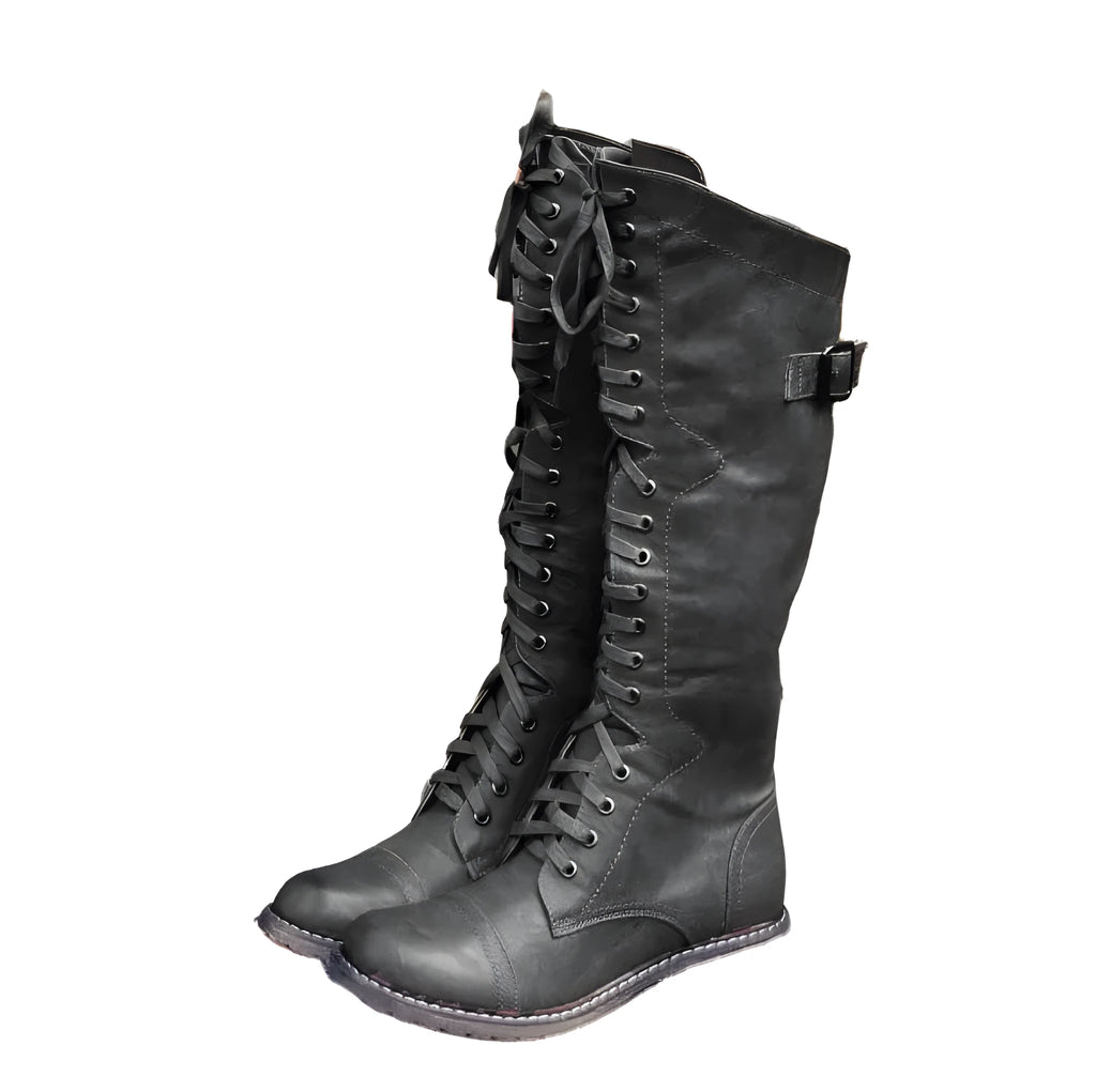 Women's black PU leather knee-high boots with a cross strap detail across the ankle.