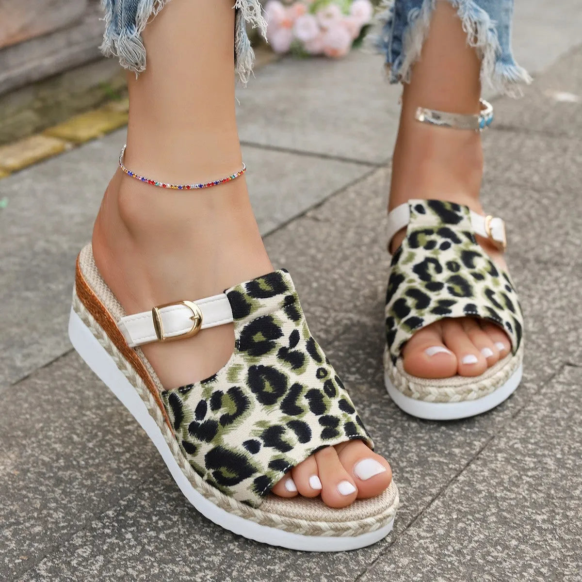 Leopard print women's platform sandals with a wedge heel and fish mouth toe in beige, on a white background.