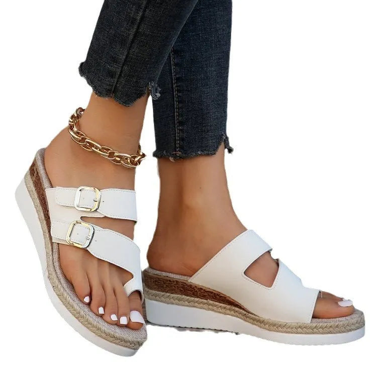 White patent leather wedge sandals with peep toe and woven design on model