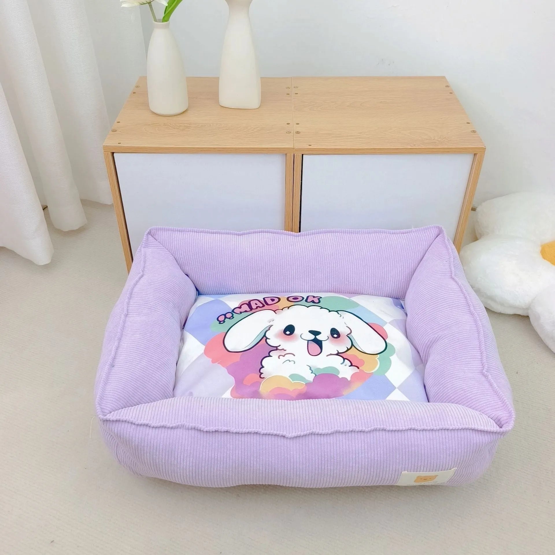 Light blue washable cotton pet winter nest for dogs and cats on a floor.