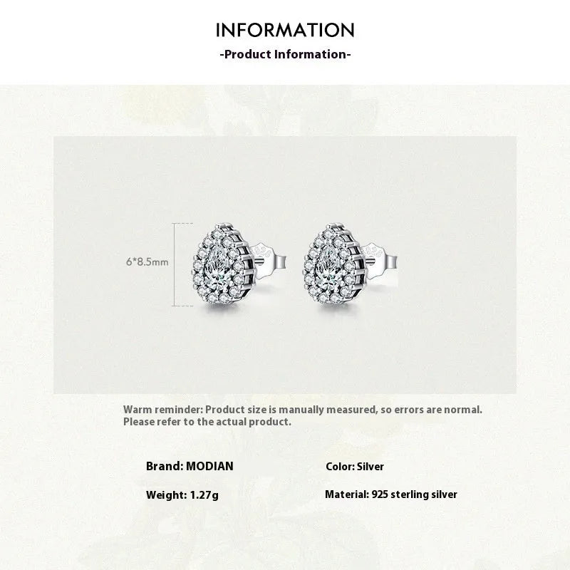 A pair of silver water drop shaped stud earrings with a diamond-cut faceted surface.