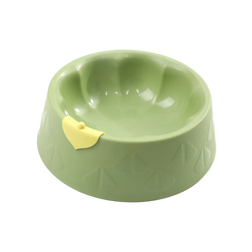 Green plastic double pet bowl for dog and cat food and water on a white surface
