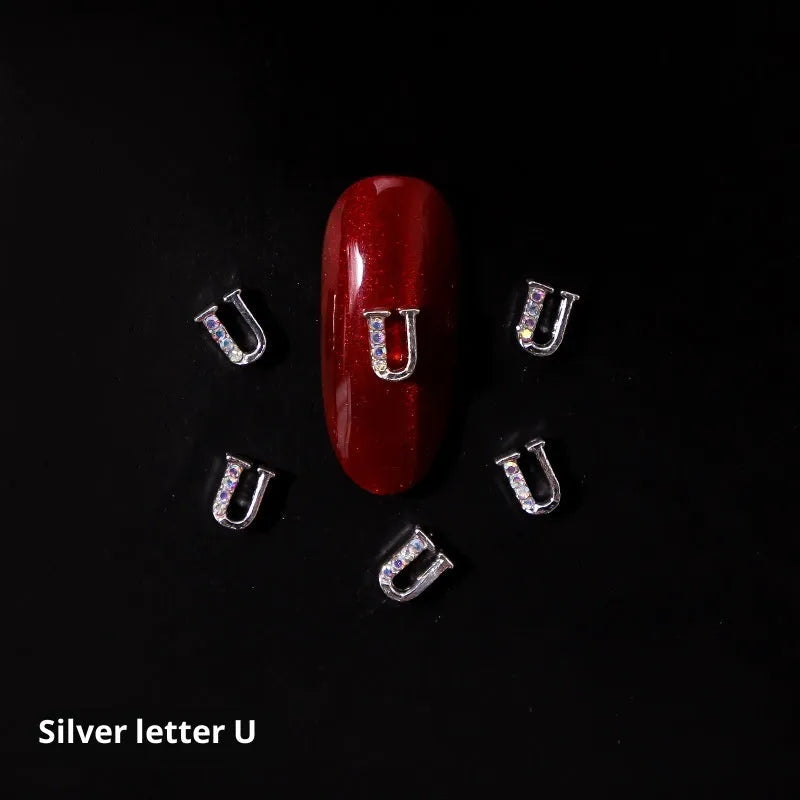Gold alloy letter A nail ornament charm with crystal detail on a square chain base