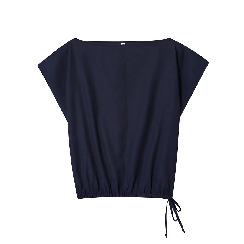 Women's linen blend long sleeve shirt with flounce detail and matching wide leg trousers set on a hanger.
