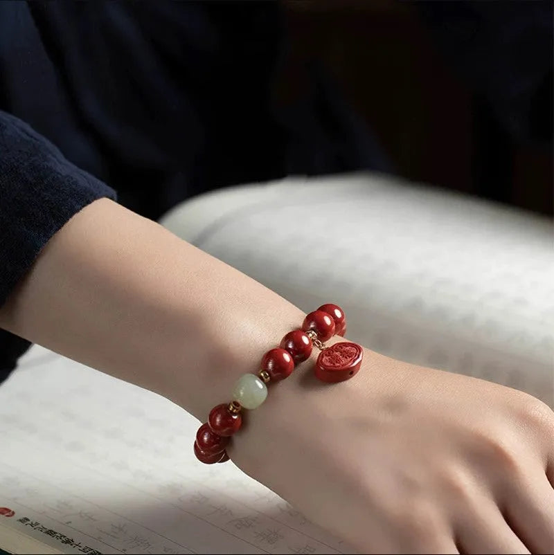 Natural cinnabar bracelet with Emperor sandstone Ping An Fu Lu design showing 8mm and 10mm bead size options.
