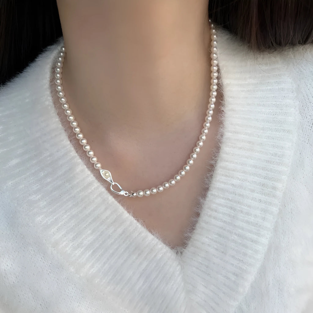 Women's sterling silver necklace with a pearl pendant on silver chain