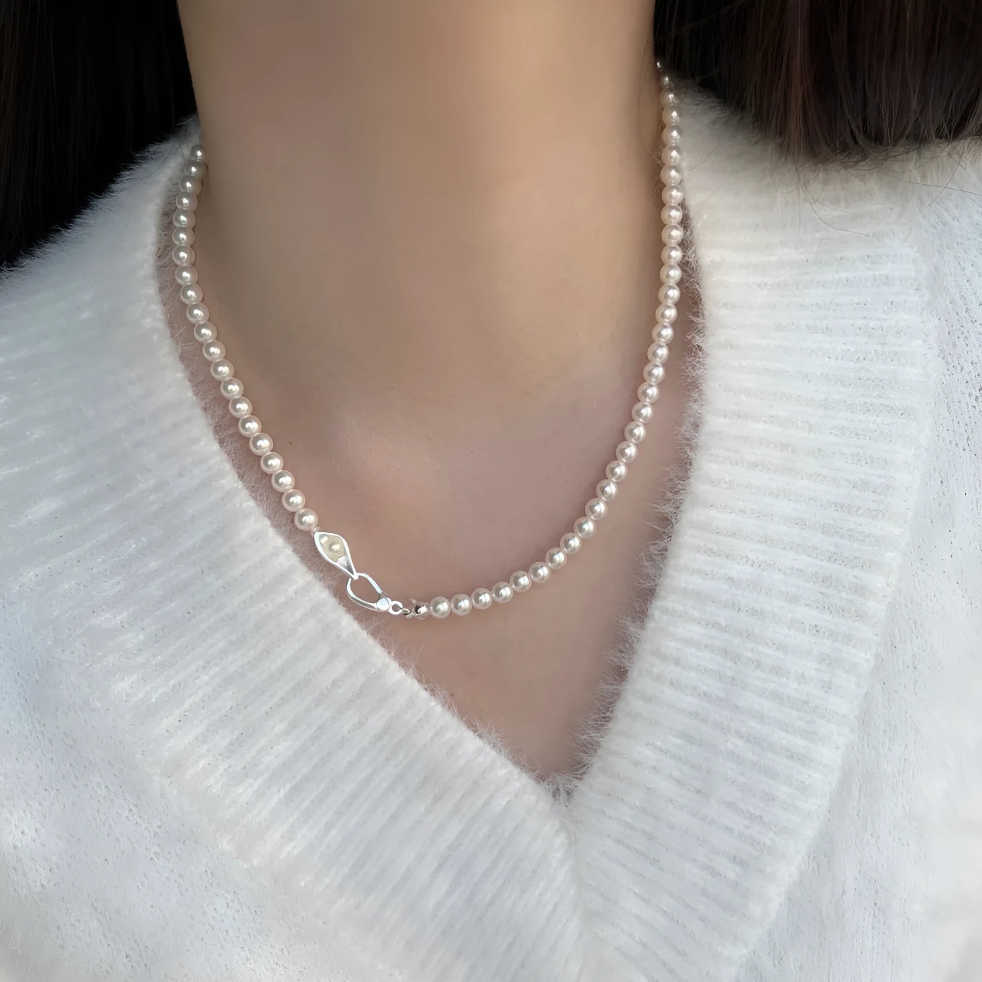 Women's sterling silver necklace with a pearl pendant on silver chain