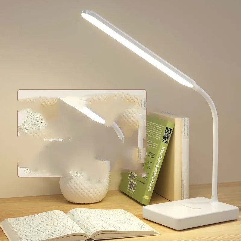 White USB charging folding LED desk lamp with touch switch and lithium battery on a desk