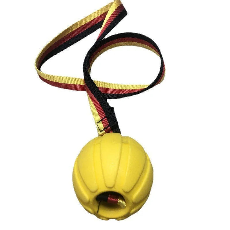 Yellow and camouflage coloured EVA foam floating dog ball with string attached for fetch and water training.