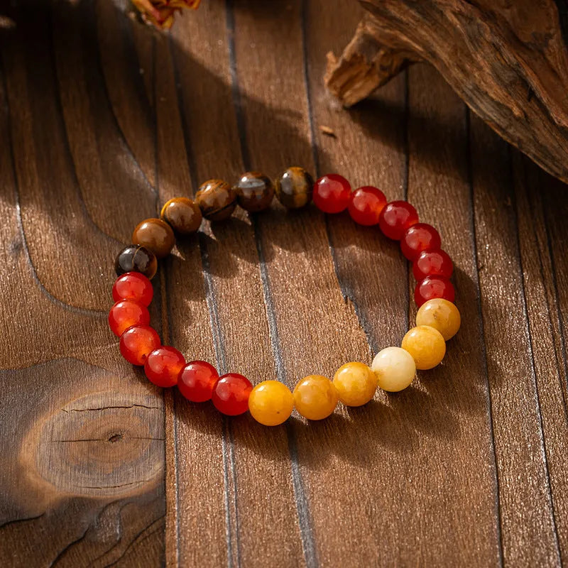 Vintage bohemian long necklace with geometric stone beads and tassel, shown with a matching shorter bracelet.