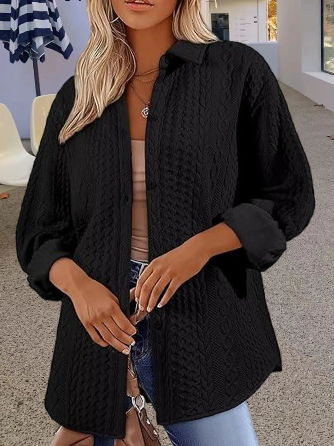Women's solid colour knitted cardigan in black, shown open-front with long sleeves and contrast trim detail.