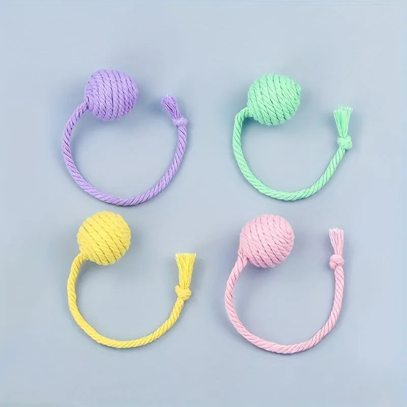 Colourful cat toy ball with rope and built-in bell available in green pink purple yellow for kittens