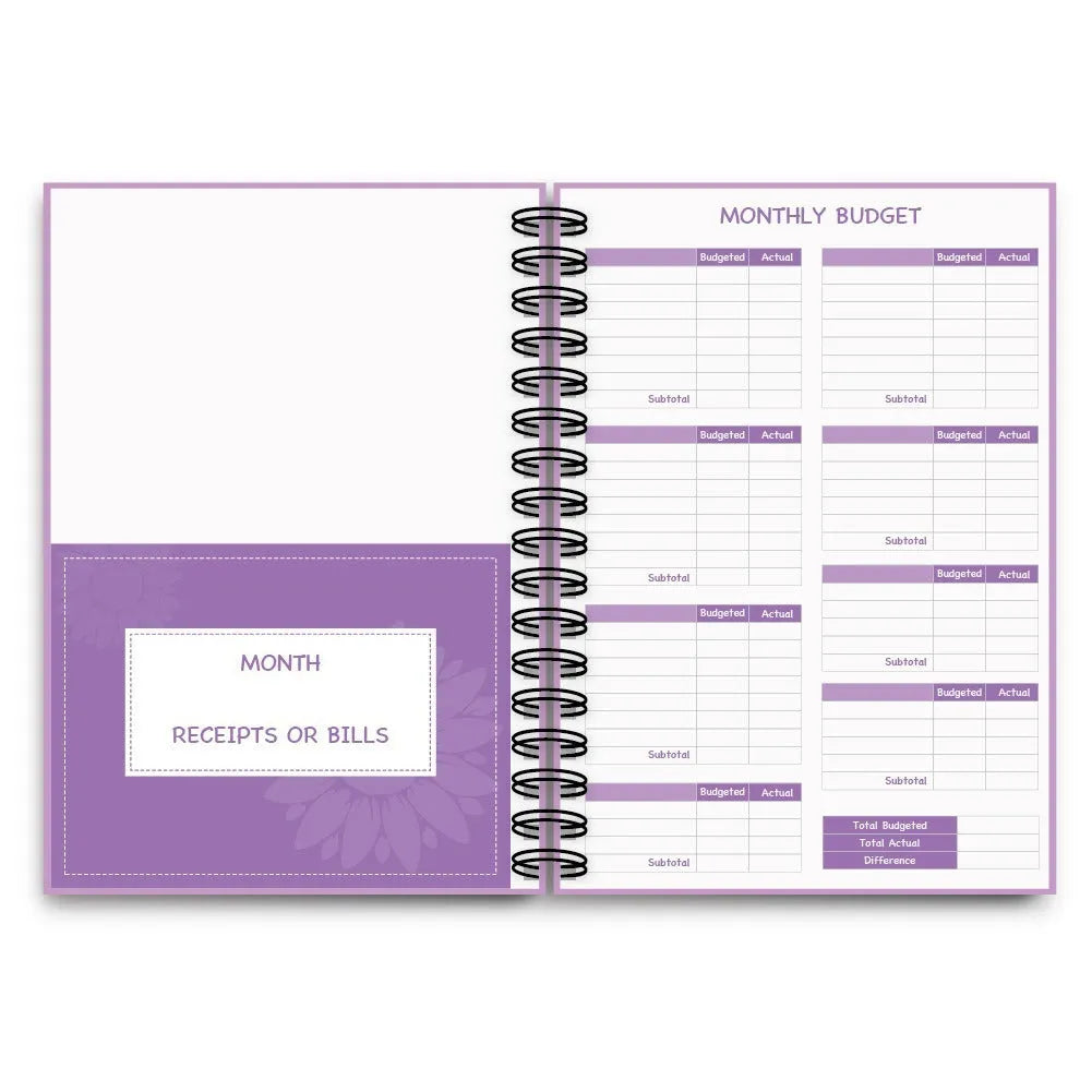 Purple coil-bound financial planning notebook with budgeting stickers and paper clips for monthly expense tracking
