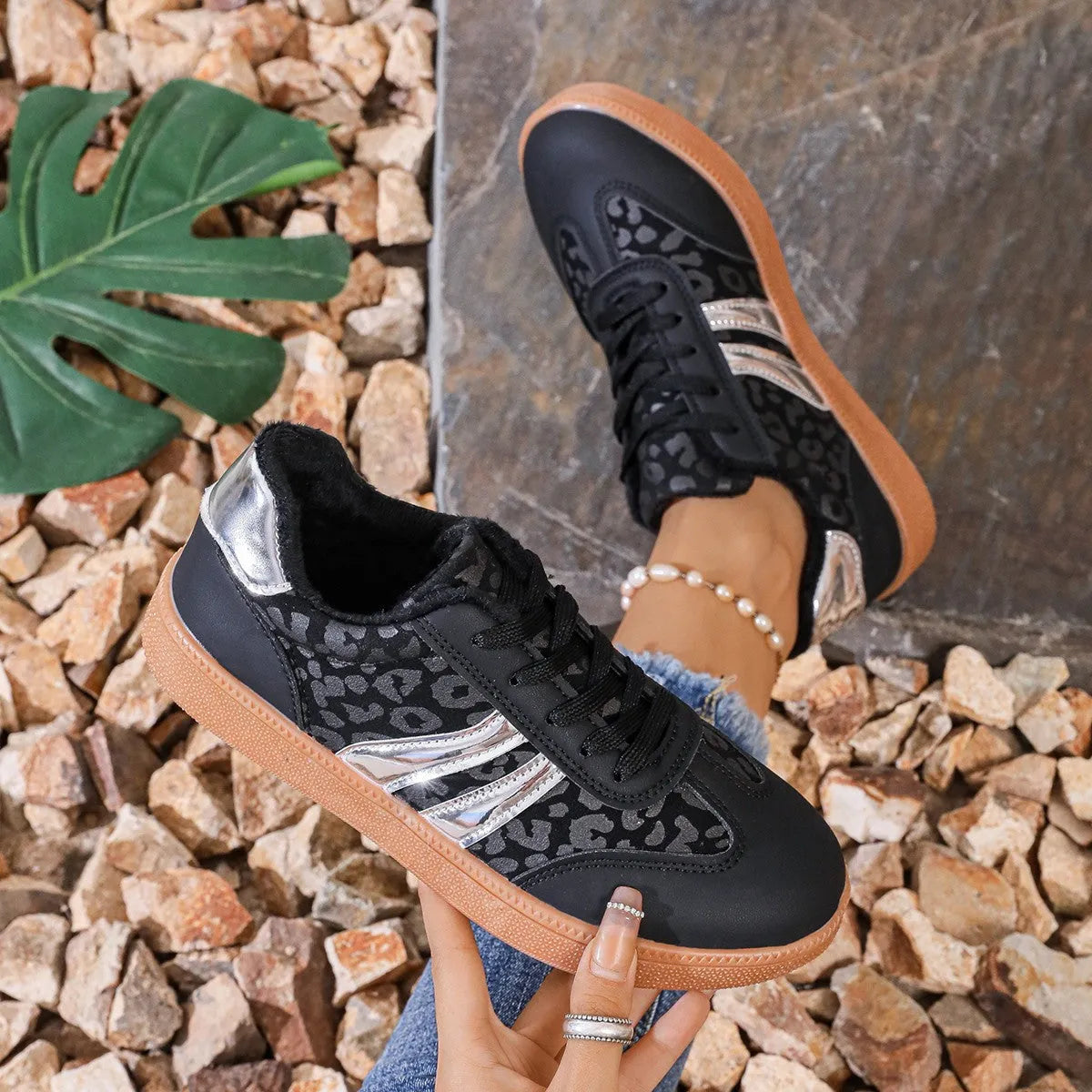 Women's casual running shoes with black microfiber upper, round toe, low top, and rubber sole against white background