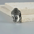 Stainless steel hollow skull Buddha earrings showing four colour finishes on geometry design