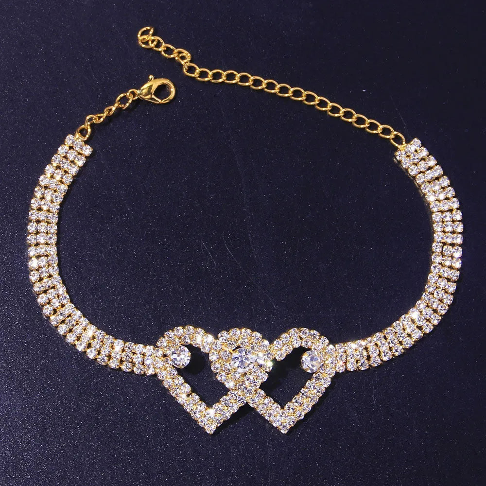 Set of two alloy double heart anklets with electroplated finish, unisex style, displayed together