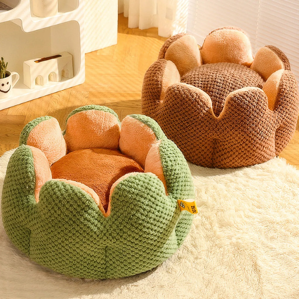 Green cactus petal shaped enclosed soft plush bed for a cat or small dog on a hardwood floor.