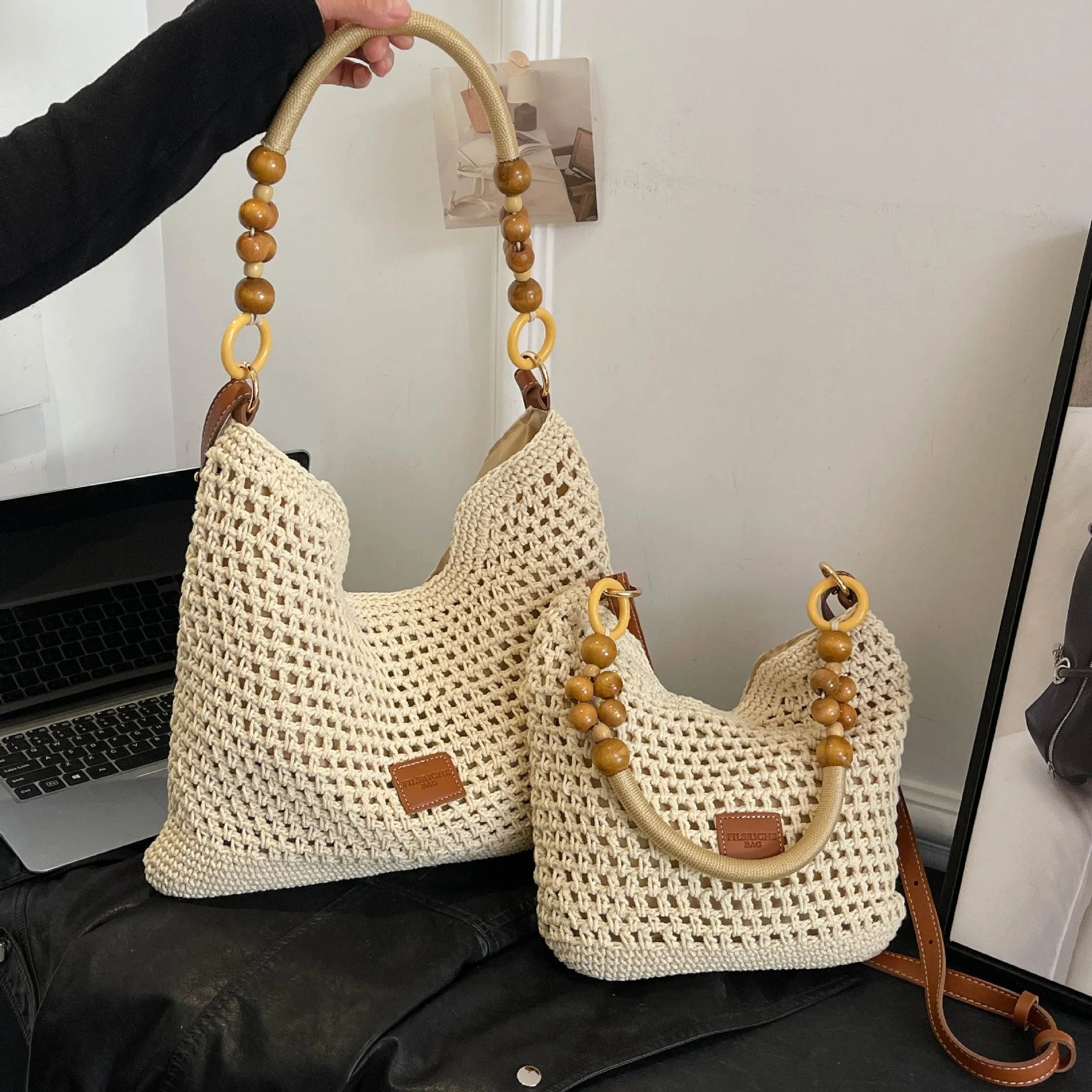 Knitted tote beach bag with contrast stitching showing crossbody strap and zip compartment