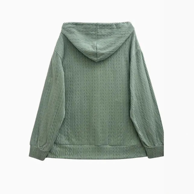 Green women's hooded zipper coat with a loose casual fit on a hanger