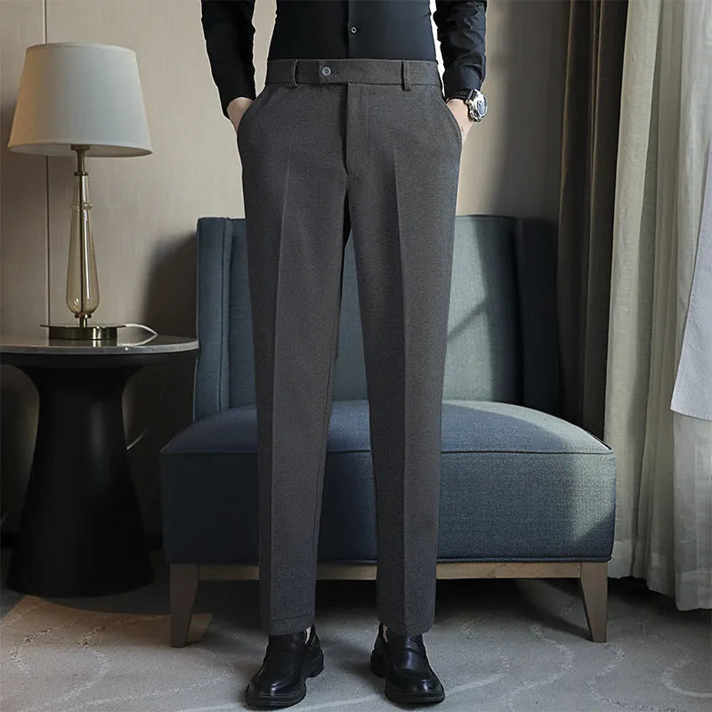 Retro brown straight leg corduroy trousers with elastic waistband laid flat.