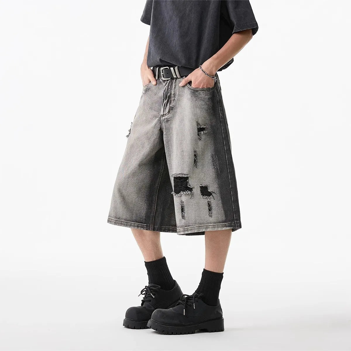 Grey cotton denim shorts with distressed hole finish and loose cropped fit