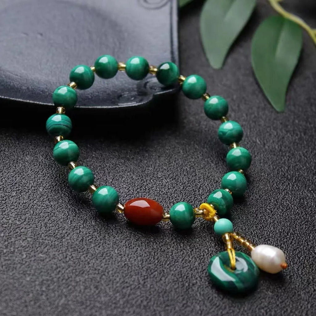 Natural malachite bracelet with southern red agate barrel beads showing green and red stone details