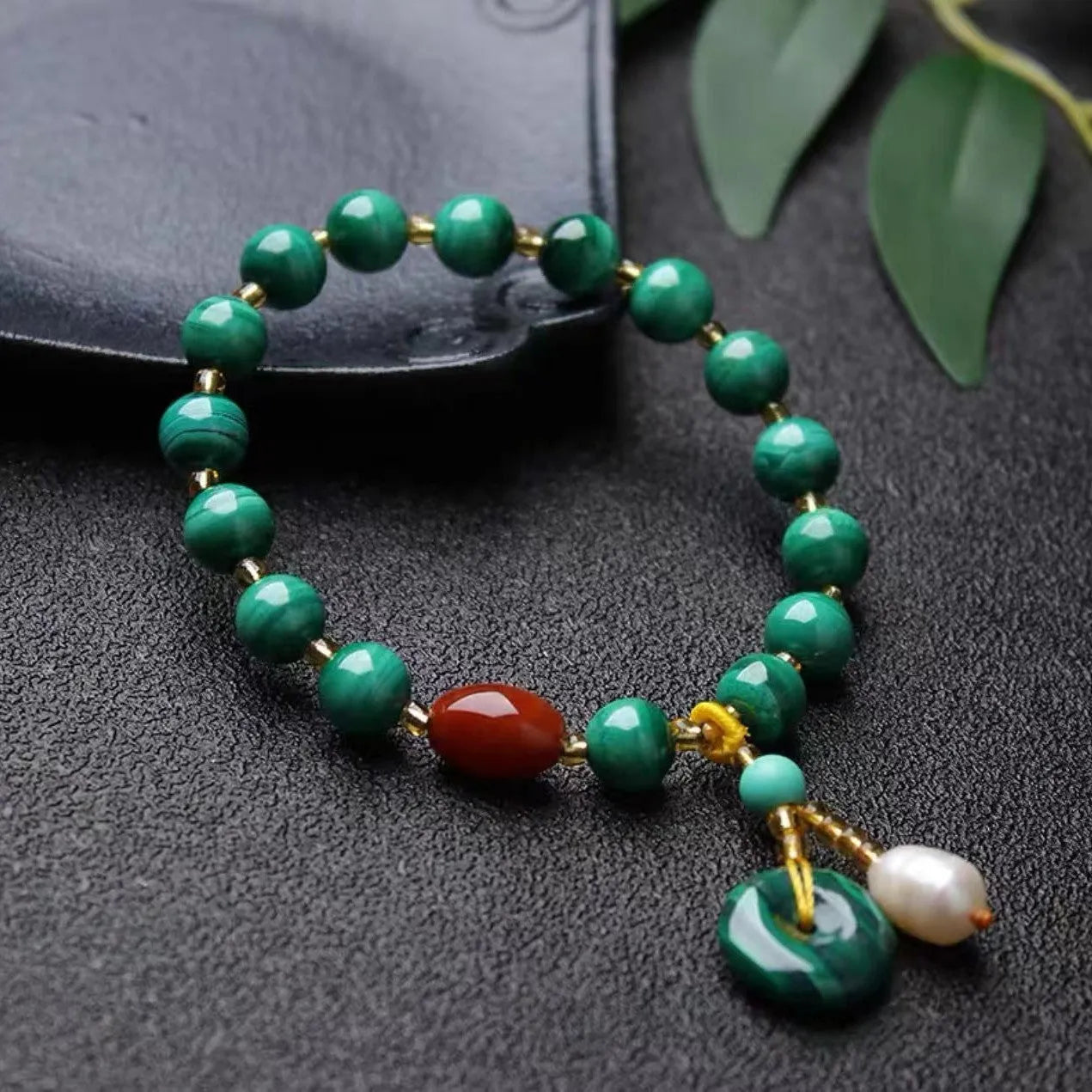 Natural malachite bracelet with southern red agate barrel beads showing green and red stone details