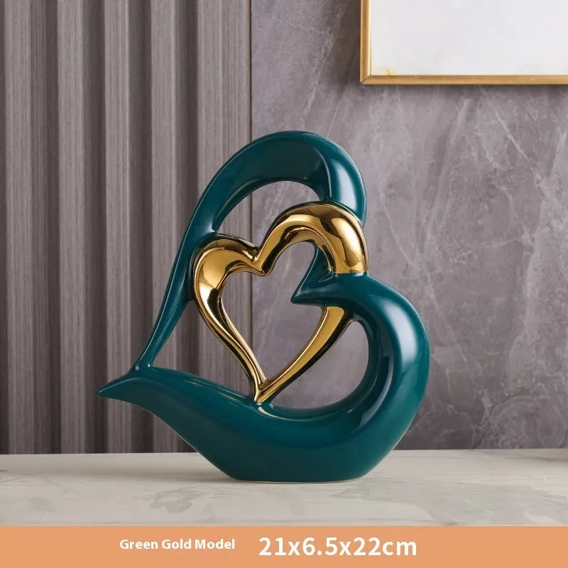 Modern white porcelain heart ornament in a metallic finish, showing its geometric shape on a table.
