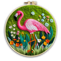Round 20x20 cm linen embroidery kit with wool felt pieces for floral design and included embroidery frame.
