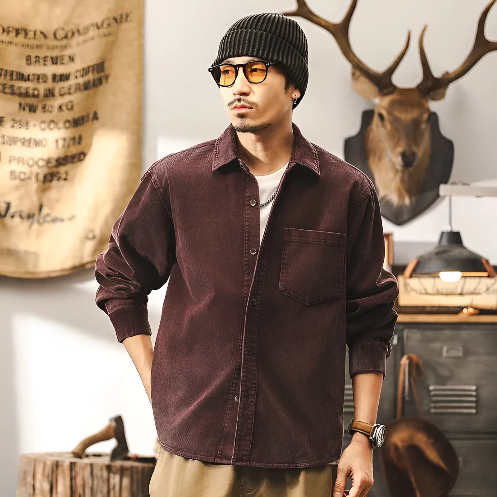 Man wearing a loose-fit black corduroy shirt jacket with long sleeves.