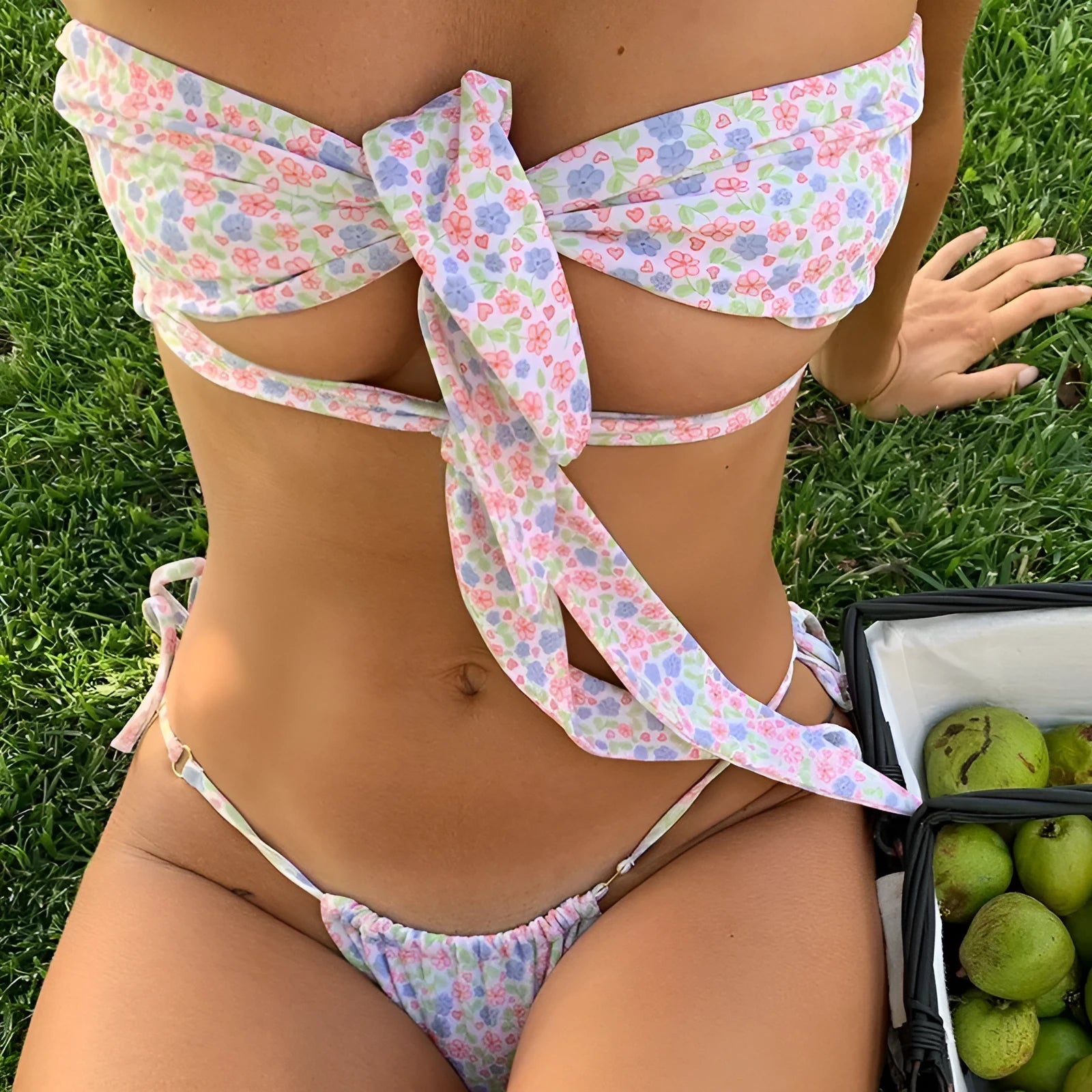 Women's lace-up back swimsuit with built-in chest pads in floral and solid colour patterns