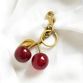 Red or pink zinc alloy cherry pendant keychain for car keys and bags.