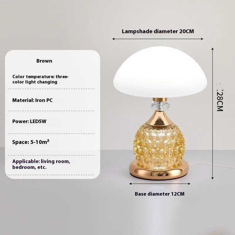 Light luxury mushroom table lamp with carved base in transparent colour on a wooden bedside table