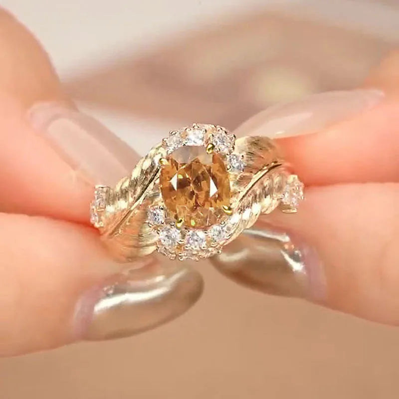 Gold colour copper women's ring with embossed feather pattern and yellow zircon stones on geometric band