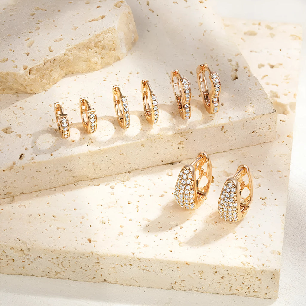 Gold plated heart shaped ear clip earrings with cubic zirconia stones on copper base