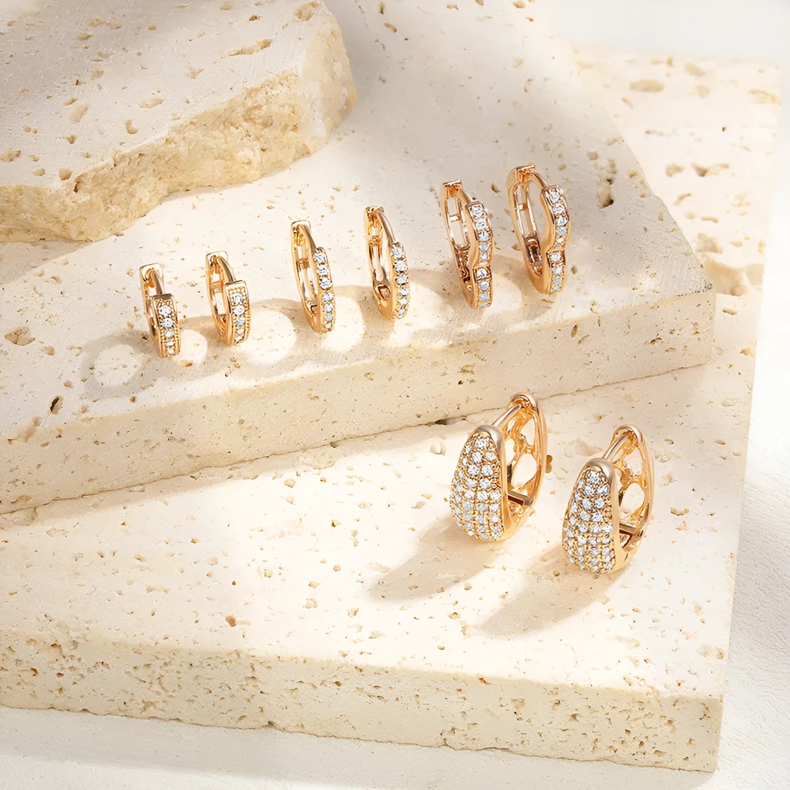 Gold plated heart shaped ear clip earrings with cubic zirconia stones on copper base
